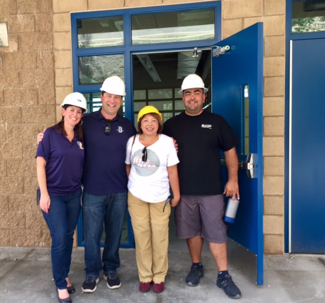 Guia Blaske with three colleagues in hard hats at a construction site visit