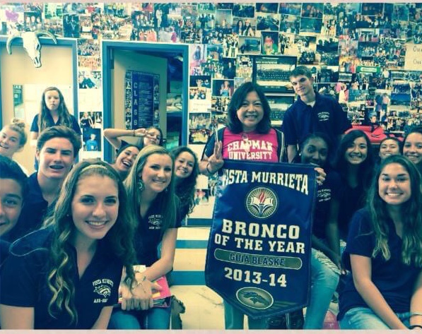 Guia Blaske with students holding a Vista Murrieta Bronco of the Year 2013-14 banner