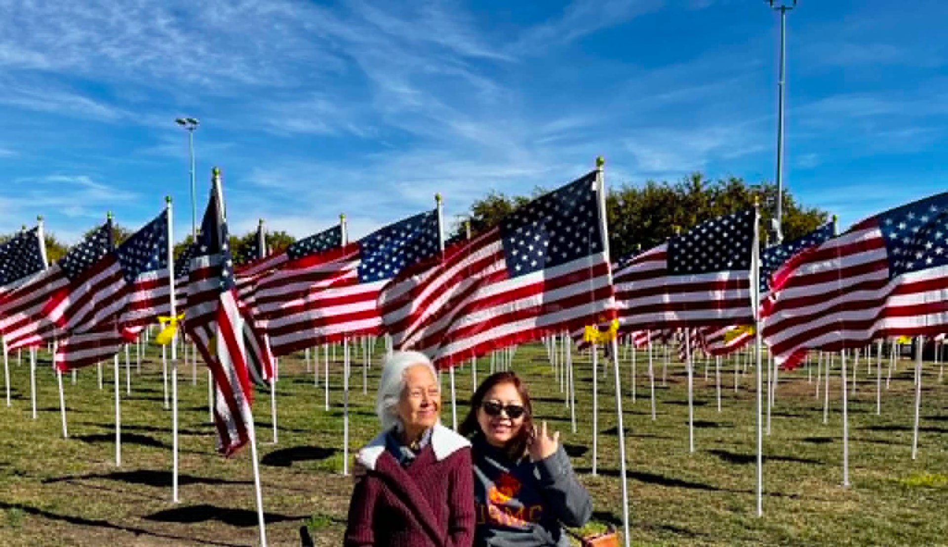 Guia Blaske with a fellow community member at the Murrieta Field of Honor, November 2022, surrounded by rows of American flags